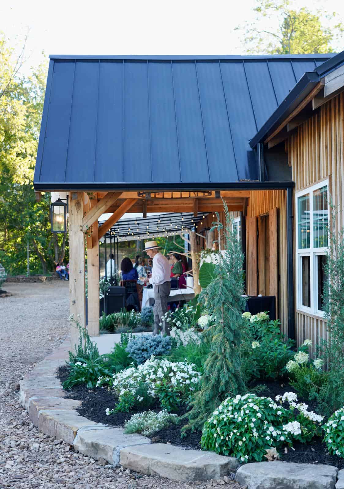 Rustic outdoor event at Belle Stone Venue with elegant garden landscaping and wooden architecture, perfect for weddings and special celebrations.