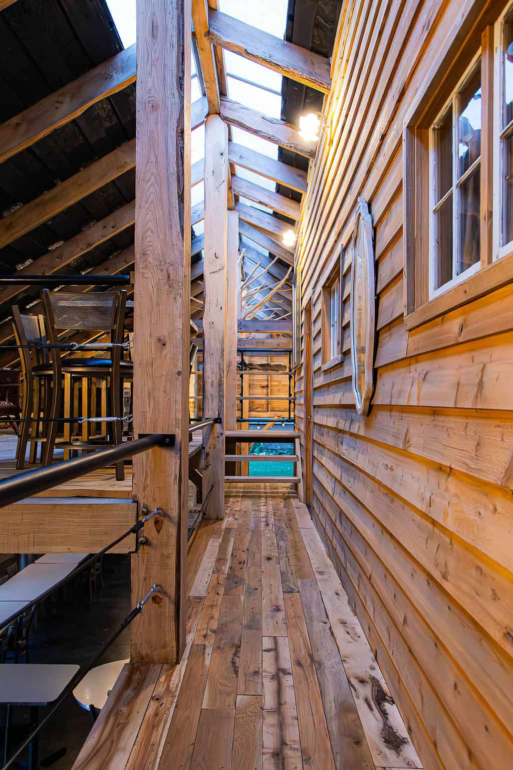 Cozy rustic wooden interior with natural timber walls and ceiling, overlooking an outdoor space, perfect for barn weddings or countryside events at Belle Stone Venue.